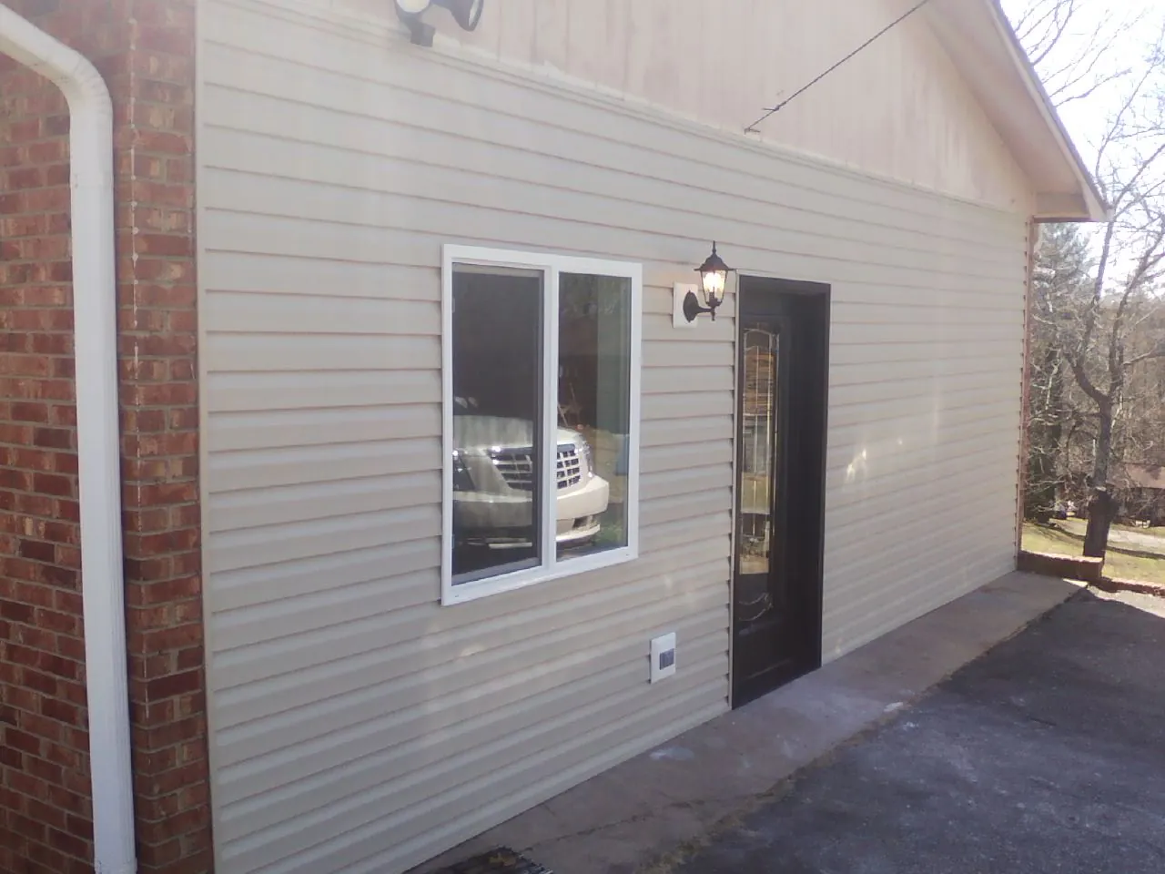 New vinyl siding and entry door on a room addition in East Longmeadow