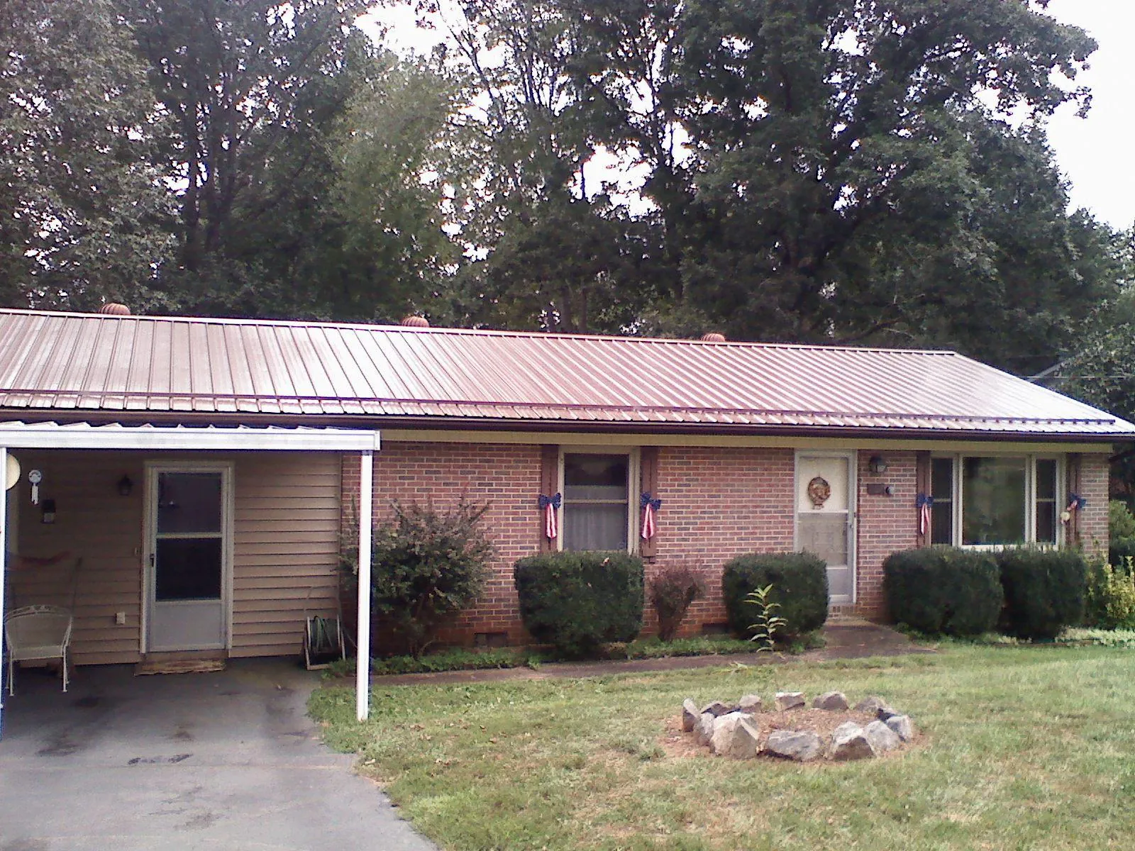 Bronze metal roof and carport on a brick ranch home — Roof Repair work by our crew in East Longmeadow